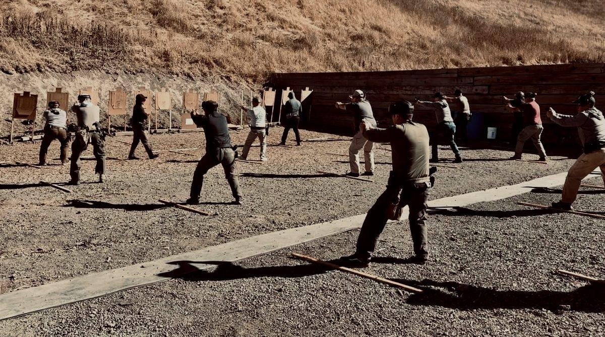 A Tactical Hyve instructor coaching students at an outdoor range